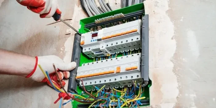 electrician installing fuses switch box
